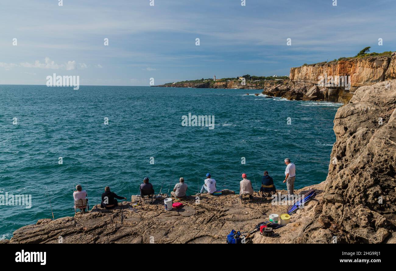 A perfect day for friends fishing, brilliant sky, sea and cliffs to the curving horizon. Stock Photo