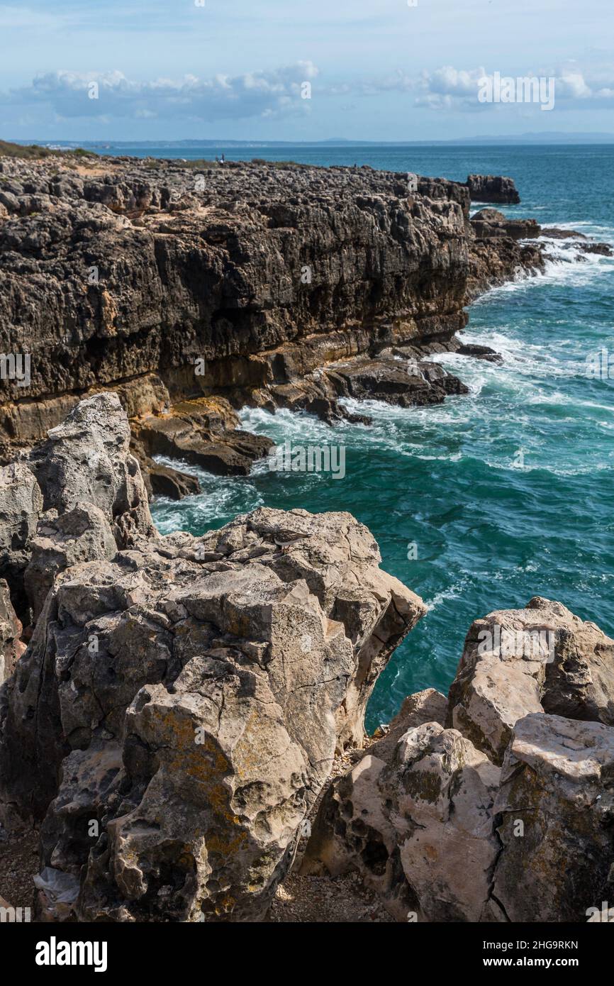 Dramatic seascape of steep imposing cliffs and the sea against them, to the horizon. Stock Photo