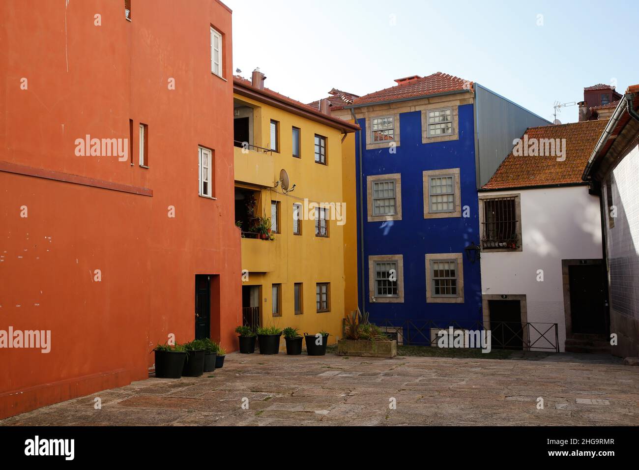 The colorful homes of Porto, Portugal grouped together in a russet, yellow, blue, and white palette. Stock Photo