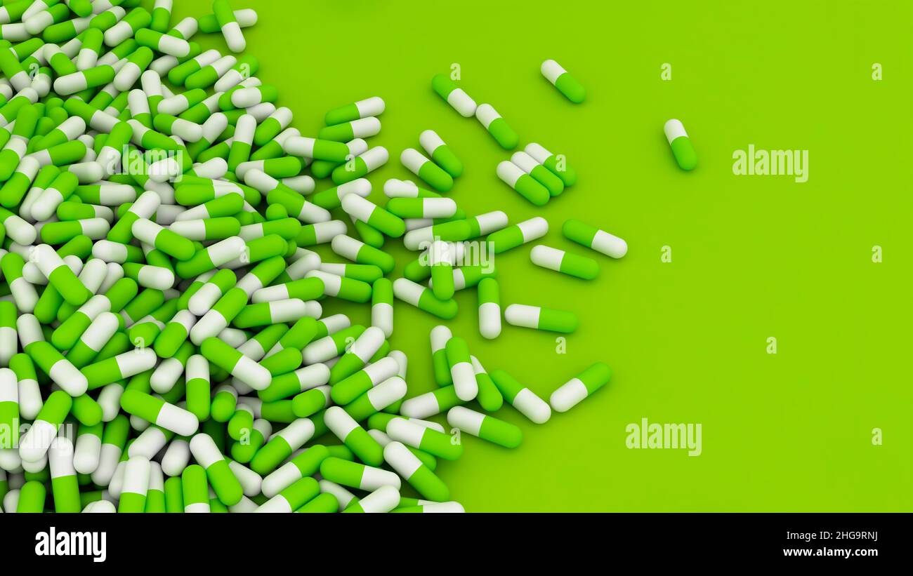 Green pills on green background with copy space area Stock Photo