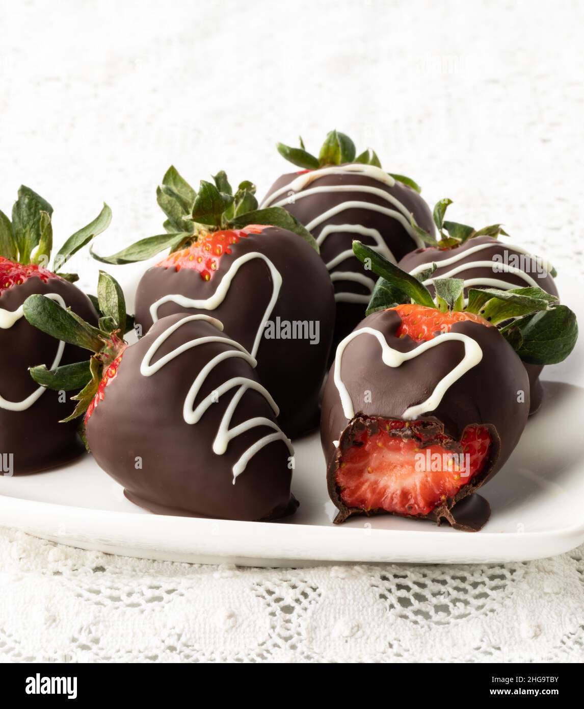 Straight on view of chocolate covered strawberries with a bite out of one.. Stock Photo