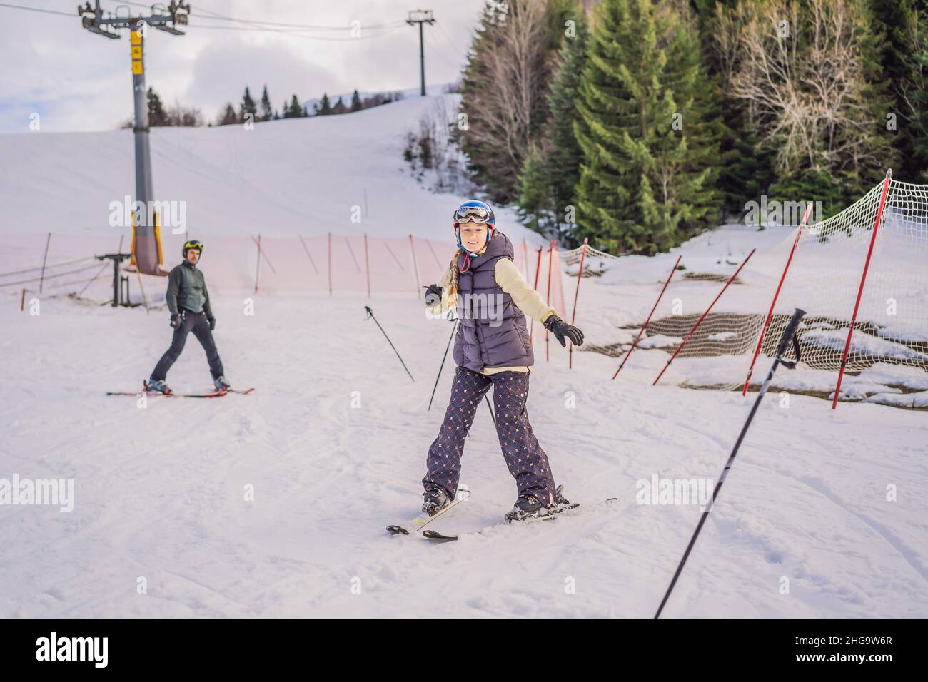 Woman learning to ski with instructor. Winter sport. Ski lesson in alpine school Stock Photo