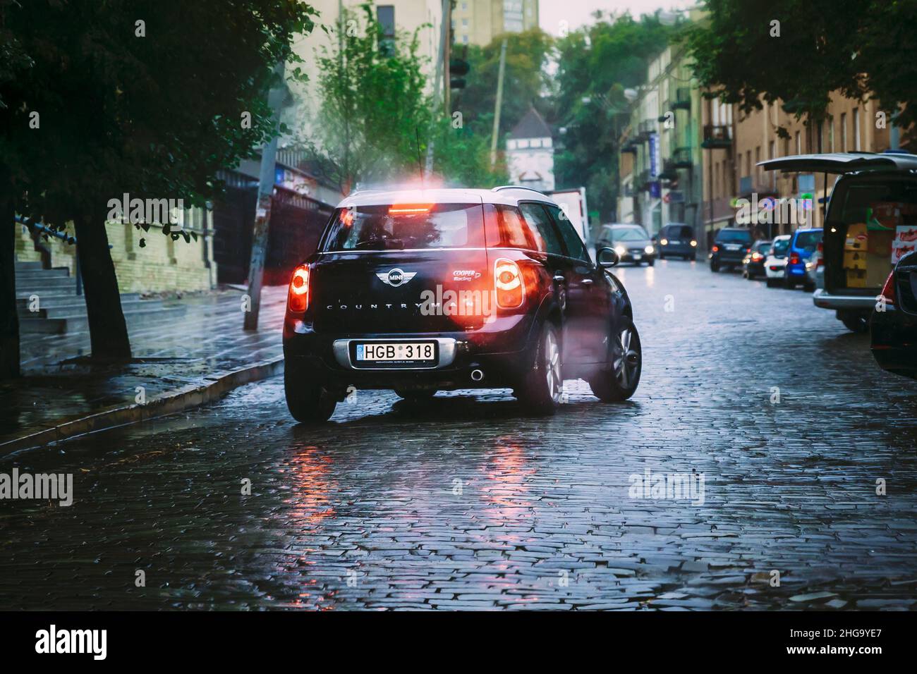 Black Color Car Mini Cooper Countryman Goes In The Rain On The Street ...