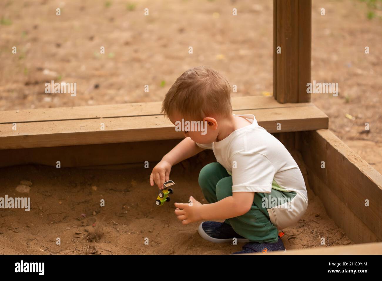 Cute little Caucasian boy playing in the playground summertime Stock ...