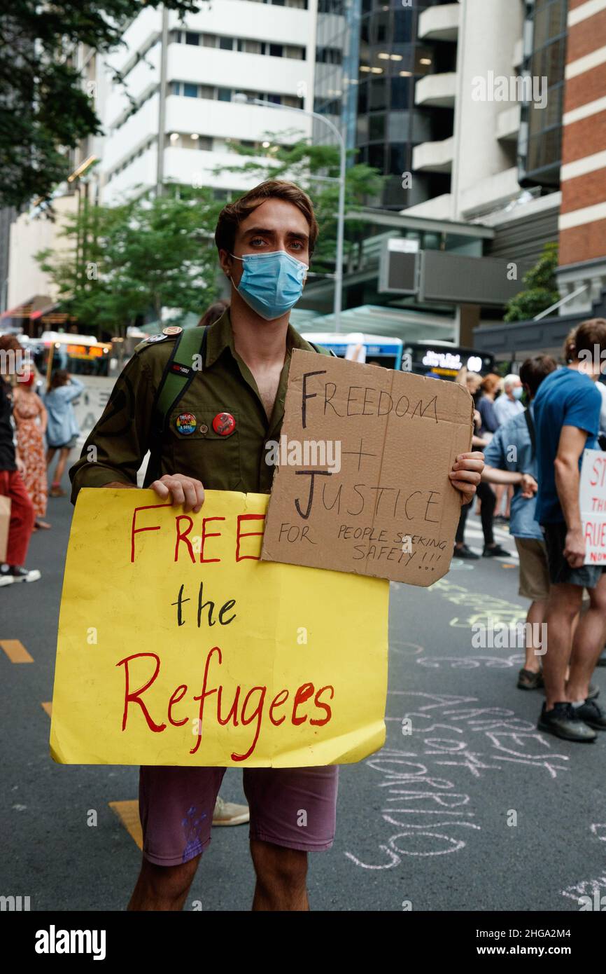 Brisbane, Australia. 19th Jan, 2022. A protester displays placards during the march through