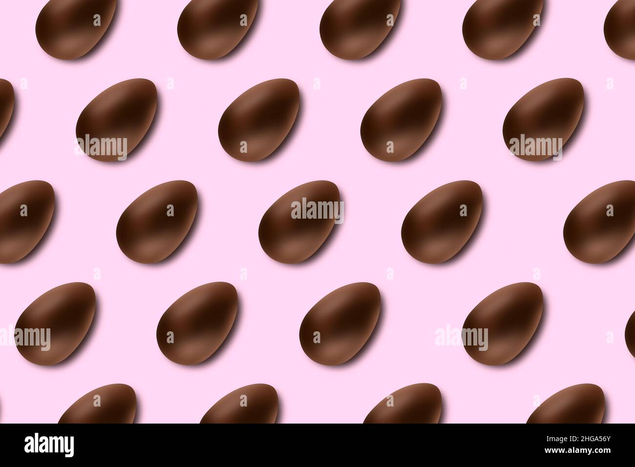 Chocolate easter eggs on pink background lined up as a pattern Stock Photo