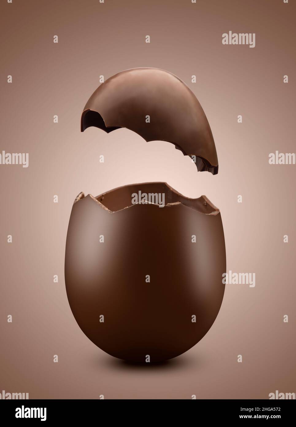 Broken chocolate easter egg on brown background Stock Photo