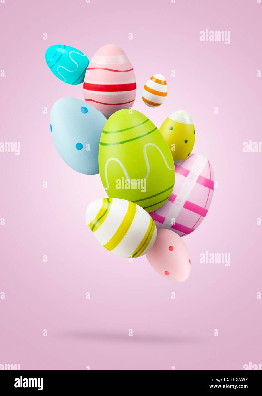 Easter eggs. Group of colored easter eggs jumping on pink background Stock Photo