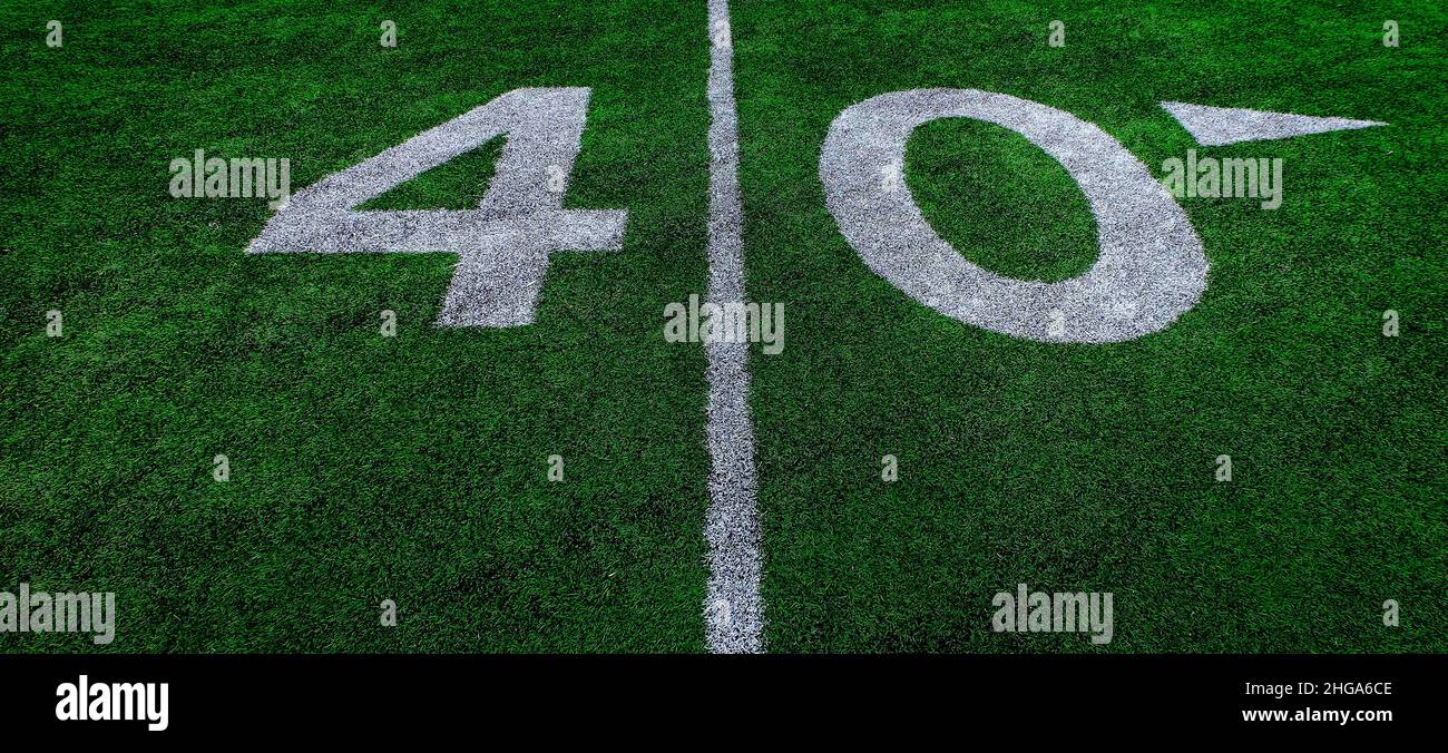 Football field green grass white yard markers to touchdown competition