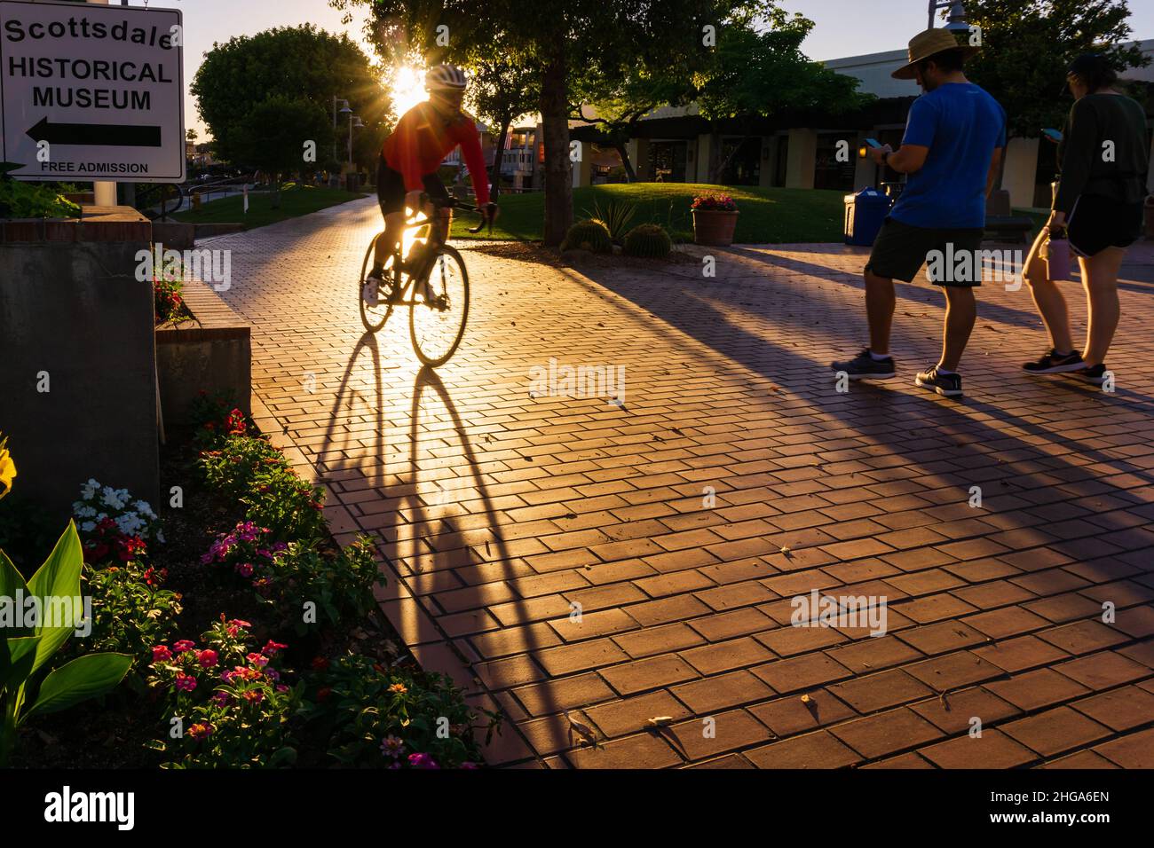 A male bicyclist riding a bicycle towards the Scottsdale Civic Center in Old Town Scottsdale, Arizona, United States. Stock Photo