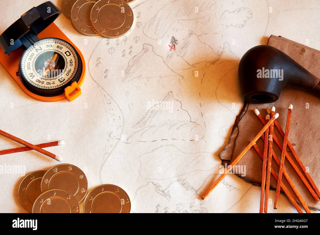 Old Pirate desk with a treasure map, compass, gold coins, and smoking pipe. Adventures, explorations and vintage concepts Stock Photo