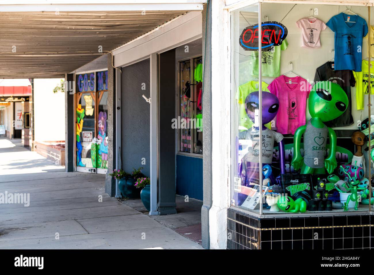 Roswell, USA - June 8, 2019: Main street road sidewalk pavement in New Mexico town with souvenir store shop and alien ufo objects on display Stock Photo