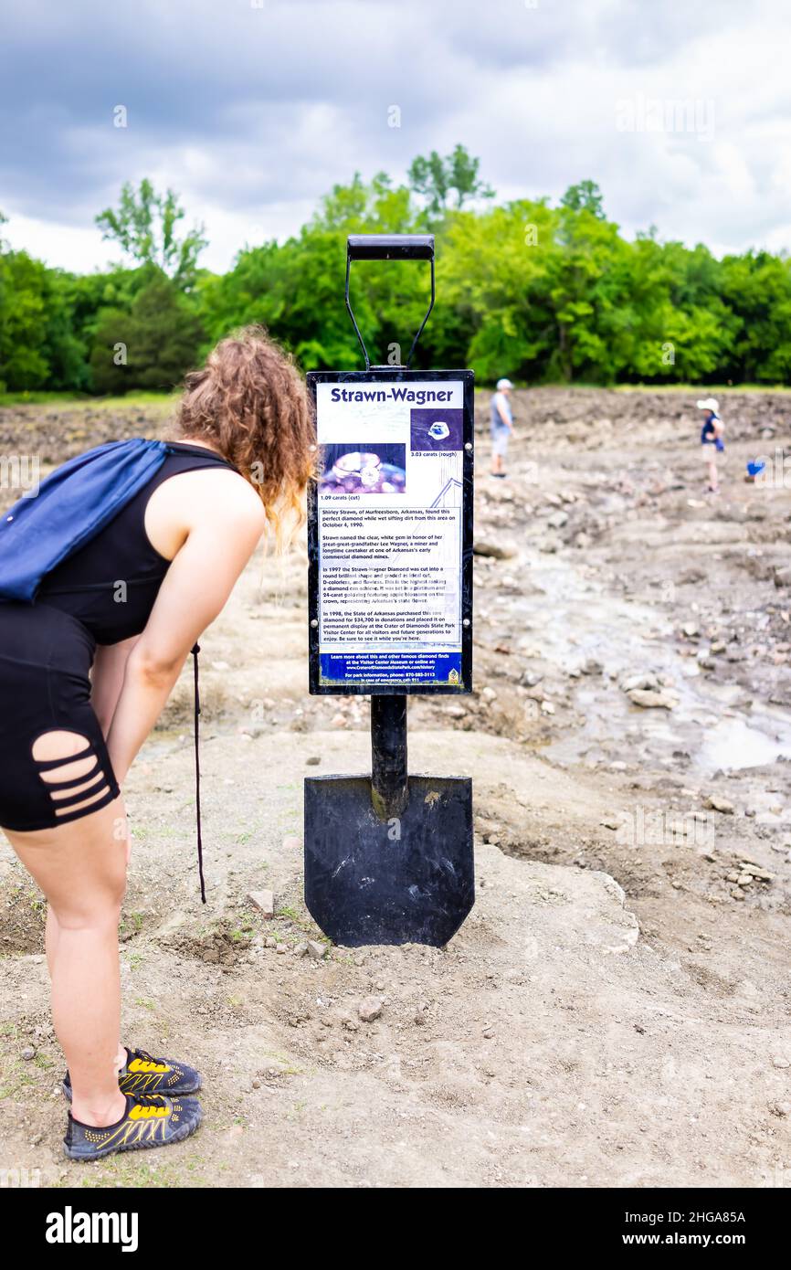 Murfreesboro, USA - June 5, 2019: Crater of Diamonds State Park in Arkansas with woman reading sign for historic Strawn-Wagner found diamond with shov Stock Photo