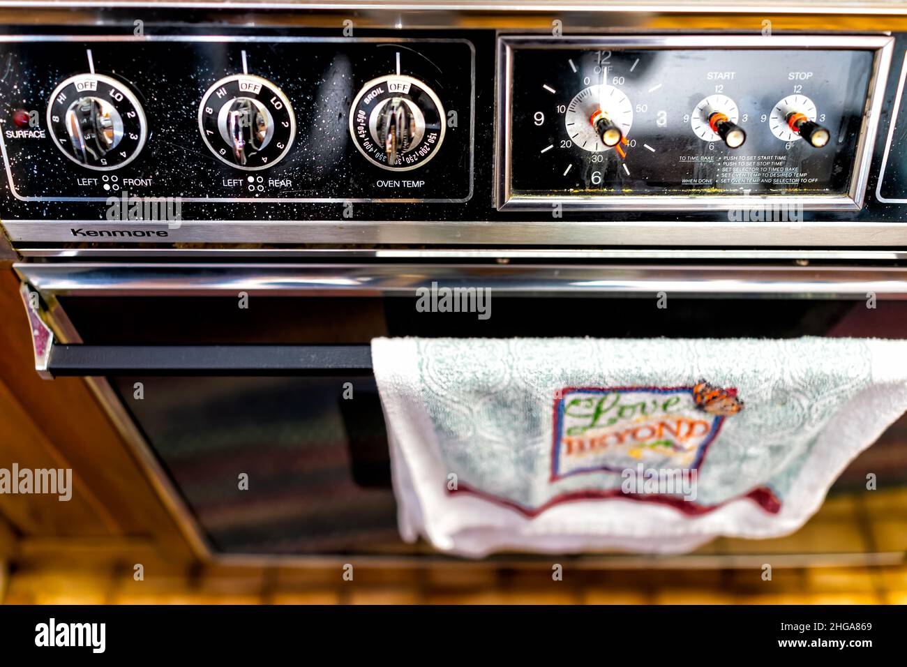 Charlottesville, USA - October 26, 2020: Old retro vintage electric oven  stove with stainless steel knobs dials closeup in kitchen by Kenmore  company Stock Photo - Alamy