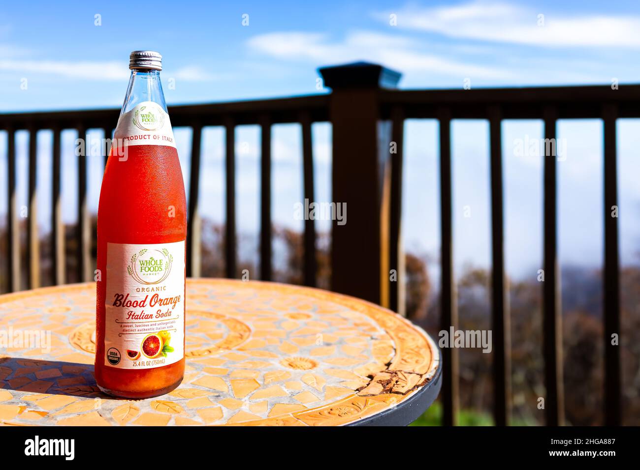 Nellysford, USA - October 26, 2020: Cold glass Italian drink bottle carbonated blood orange soda storebought at Whole Foods and label sign outside bal Stock Photo