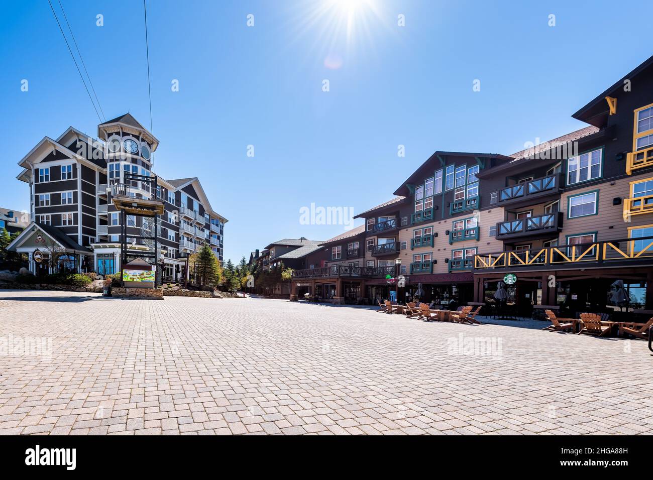 Snowshoe, USA - October 6, 2020: Wide angle view of cobbled square in Snow Shoe mountain town village store restaurant Starbucks coffee outside outdoo Stock Photo