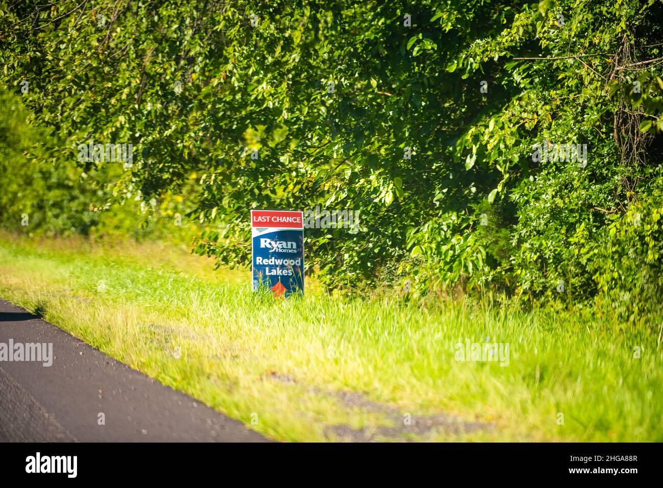 Culpeper, USA - August 30, 2020: Advertisement street sign in rural Virginia for last chance text for Ryan homes builder new modern community called R Stock Photo