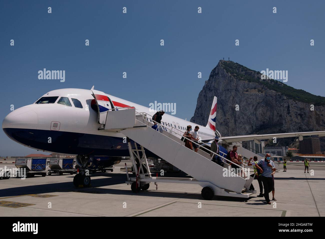 Passengers leaving a British Airways plane parked at Gibraltar International Airport, Gibraltar, July 2021 Stock Photo