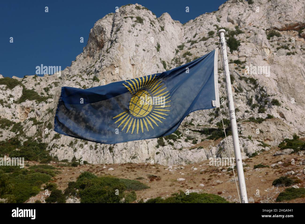 A Commonwealth of Nations flag flying on Catalan Bay, a bay and fishing village on the east coast of Gibraltar, July 2021 Stock Photo