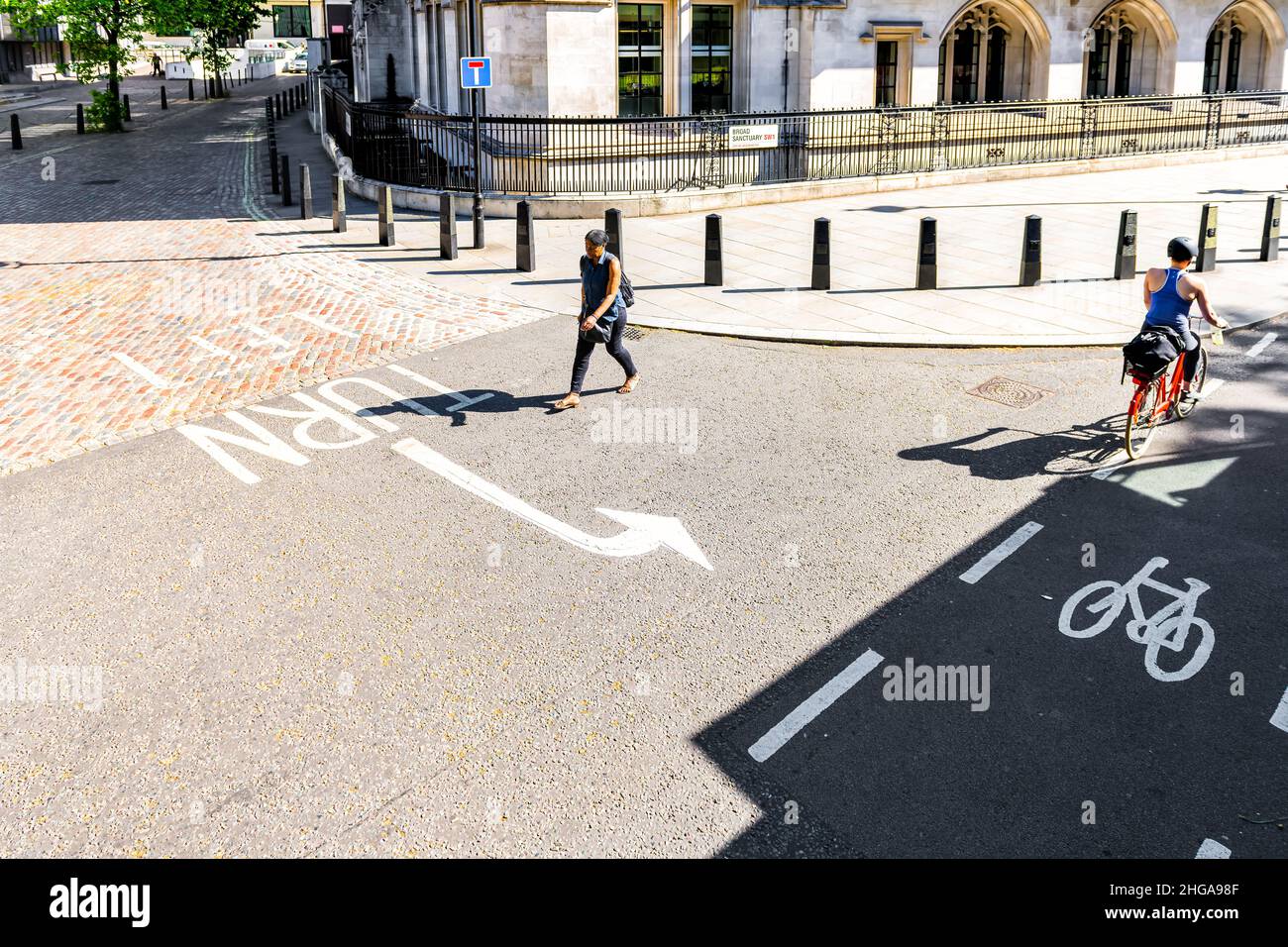 London, UK - June 22, 2018: High angle view on Royal Court of Justice in London with people walking on sidewalk pavement on sunny summer day Stock Photo