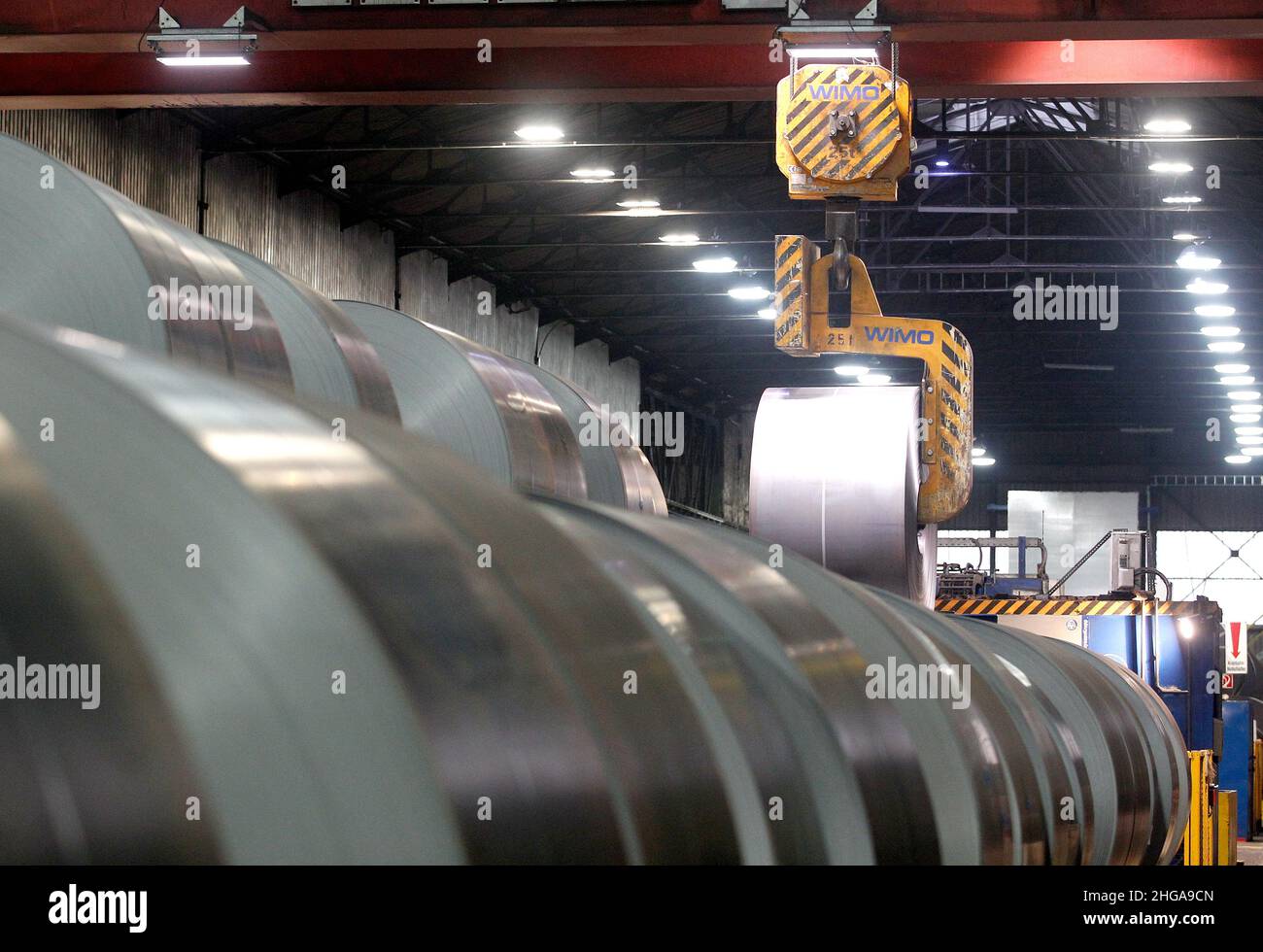 Gelsenkirchen, Germany. 19th Jan, 2022. Coils are transported by a crane at thyssenkrupp for further processing into CO2-reduced special steel for transformers. Germany's biggest steel producer now also sells special sheets for the energy industry, the production of which produces around 50 percent less carbon dioxide overall than conventional production. Credit: Roland Weihrauch/dpa/Alamy Live News Stock Photo