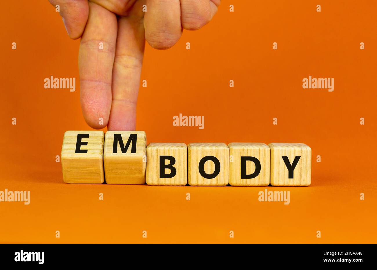 Body and embody symbol. Doctor turns wooden cubes and changes the ...