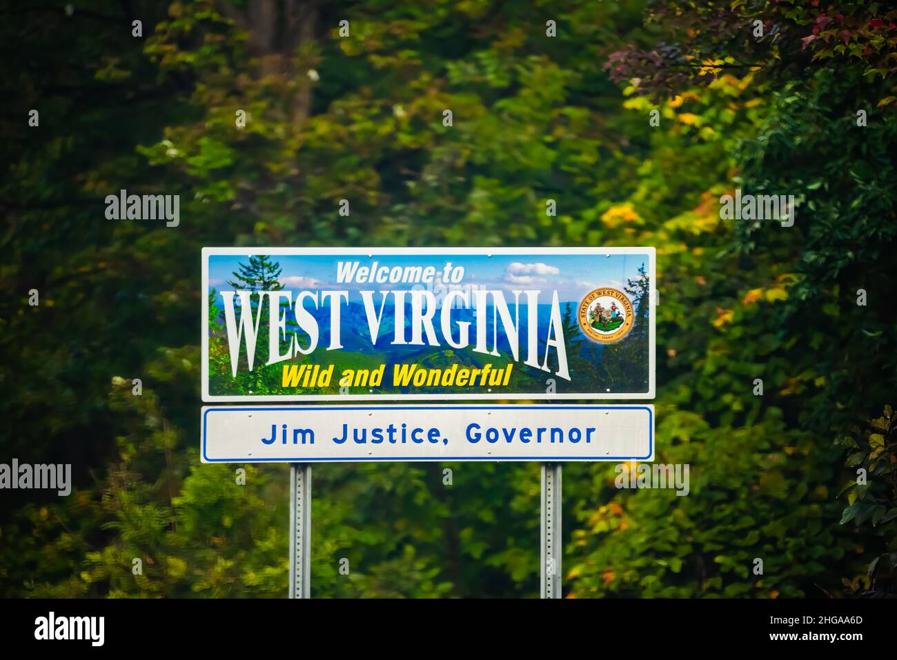 Wardensville, USA - October 5, 2020: Welcome to West Virginia sign text Wild and Wonderful with mountains picture and blue sky by Virginia border and Stock Photo