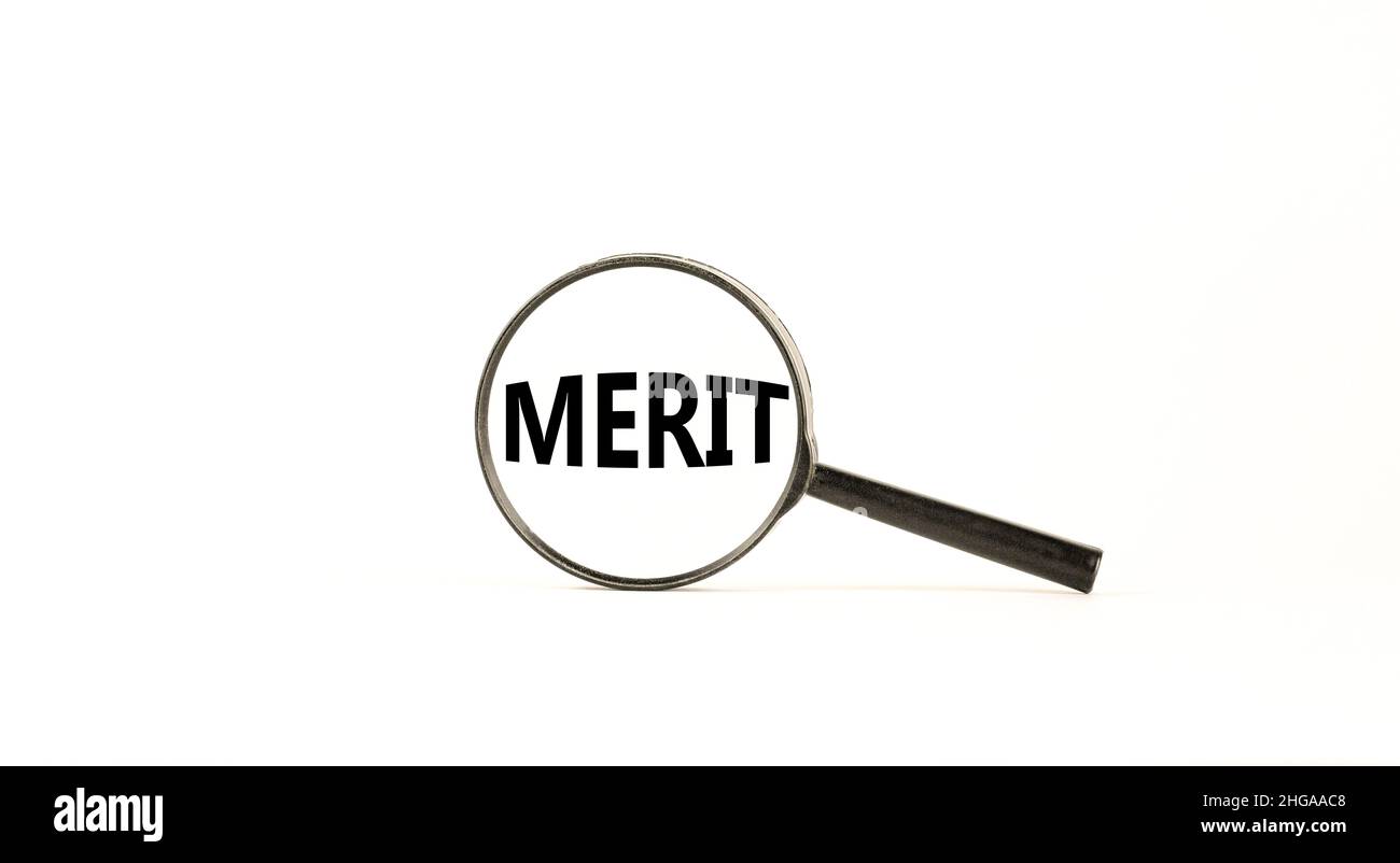 Merit symbol. Magnifying glass with word merit on a beautiful white table,  white background. Businessman hand. Business and merit concept, copy space  Stock Photo - Alamy