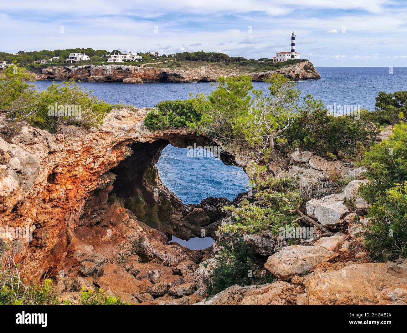Natural arch opposite to the lighthouse of Portocolom or Porto Colom, Majorca, Mallorca, Balearic Islands, Spain Stock Photo