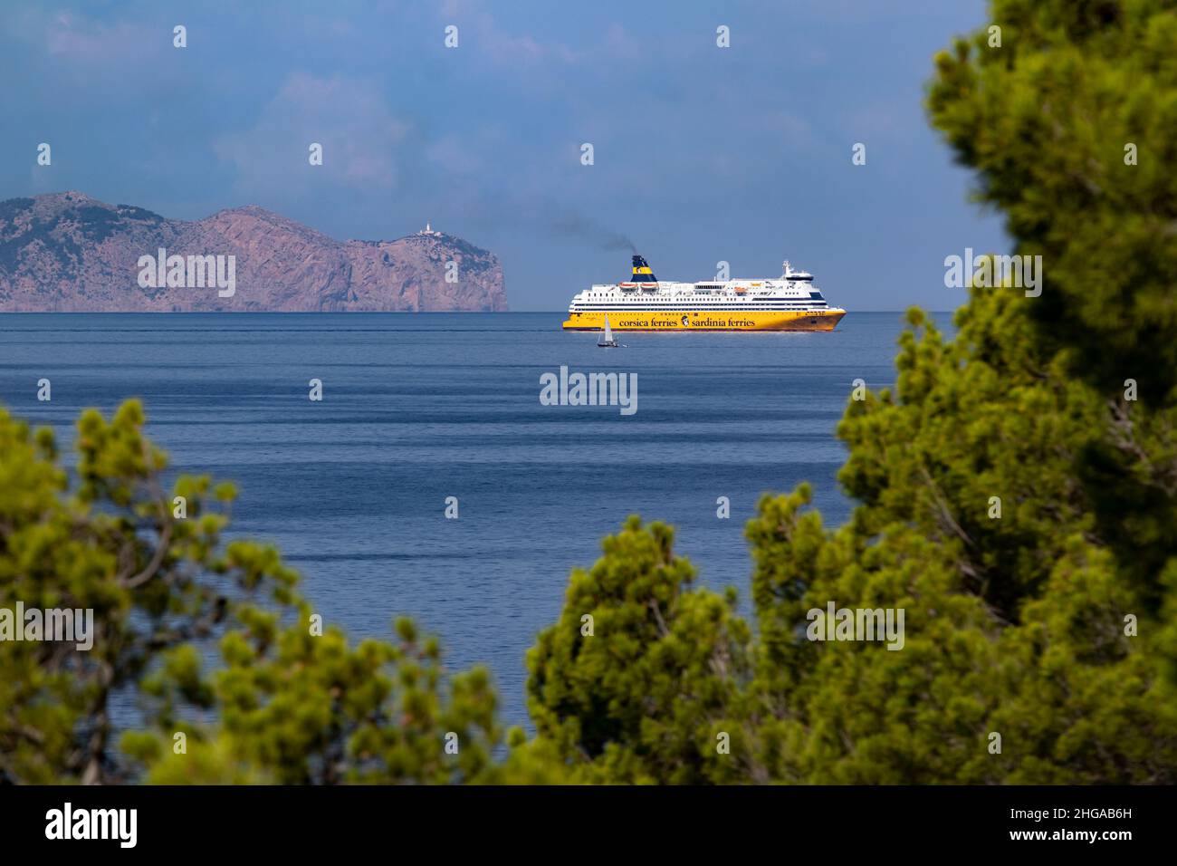 Ferry of the Corsica Ferries - Sardinia Ferries line and a small sailboat in front of the Cap de Formentor, Majorca, Mallorca, Balearic Islands, Spain Stock Photo