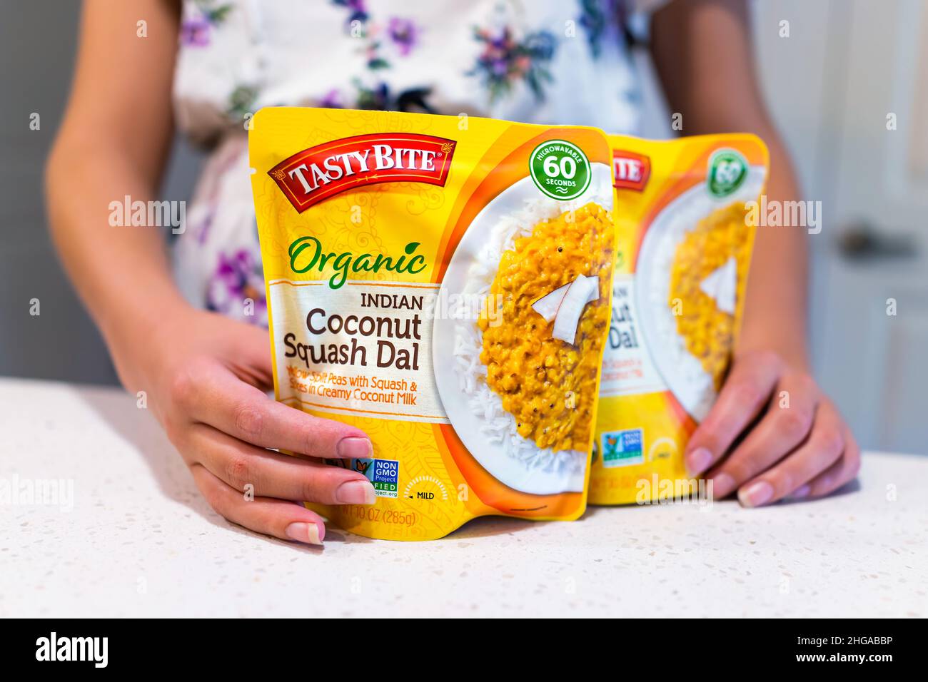Naples, USA - August 25, 2021: Tasty Bite brand gourmet sign closeup of packaged organic healthy coconut squash dal Indian yellow split peas label wit Stock Photo