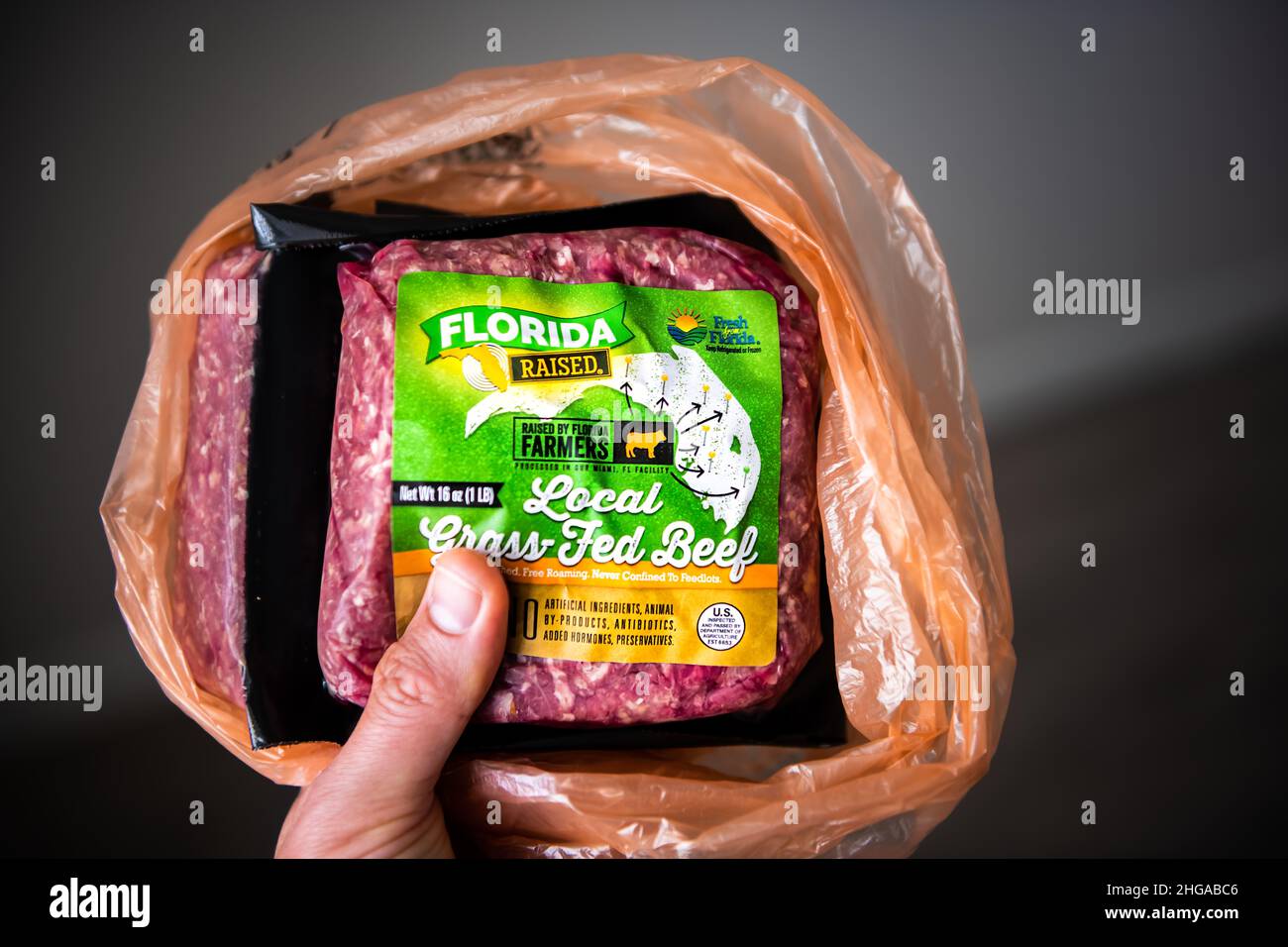 Naples, USA - September 1, 2021: Fresh from Florida brand sign closeup of packaged free range local grass-fed raised red raw beef ground meat bought a Stock Photo