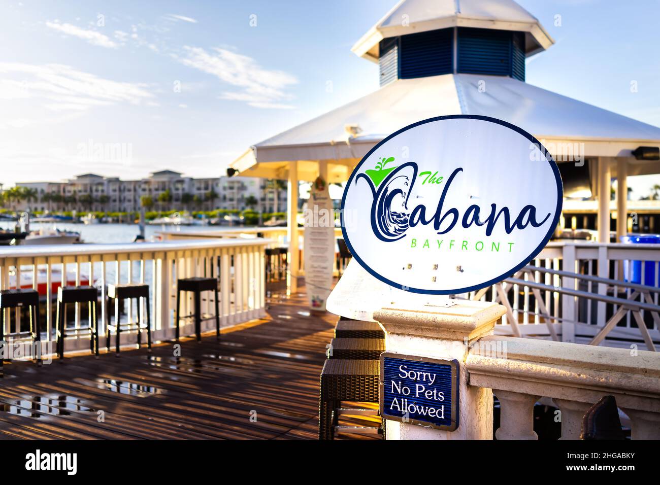 Naples, USA - September 13, 2021: Bayfront place area with water harbor marina dock and Cabana cafe waterfront restaurant with nobody in evening sunse Stock Photo