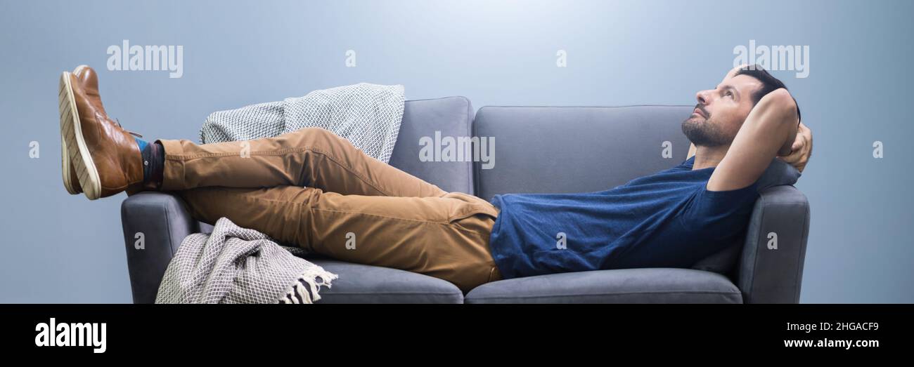 Photo Of Man Relaxing On Sofa At Home Stock Photo