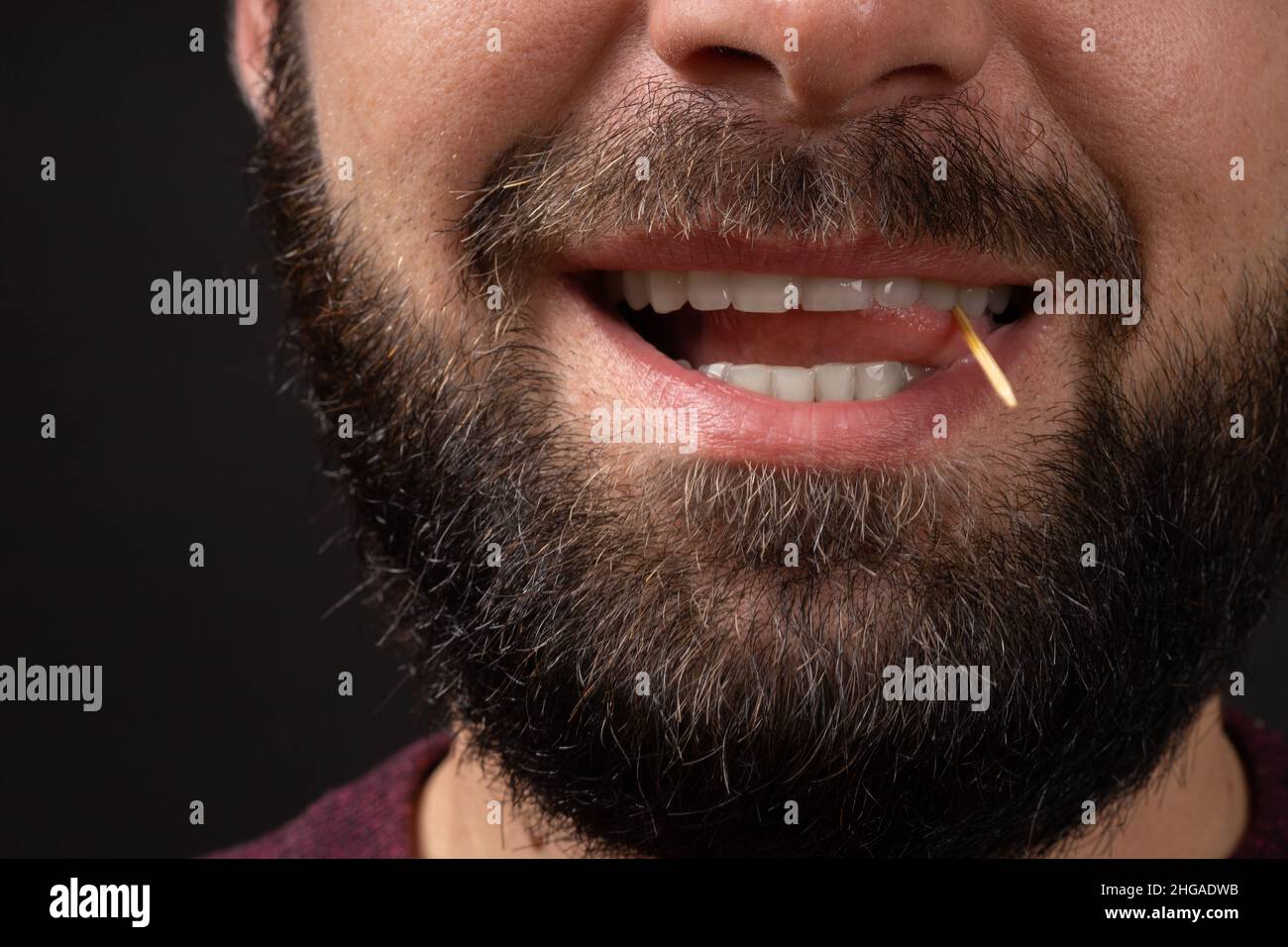 smiling male unshaven face closeup with open mouth and tongue playing