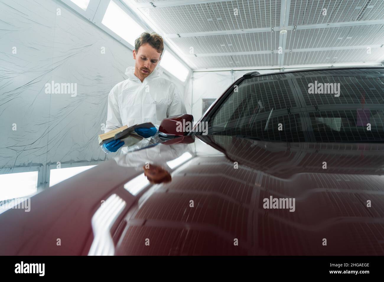 Auto colorist in the painting chamber selects the color of the car ...