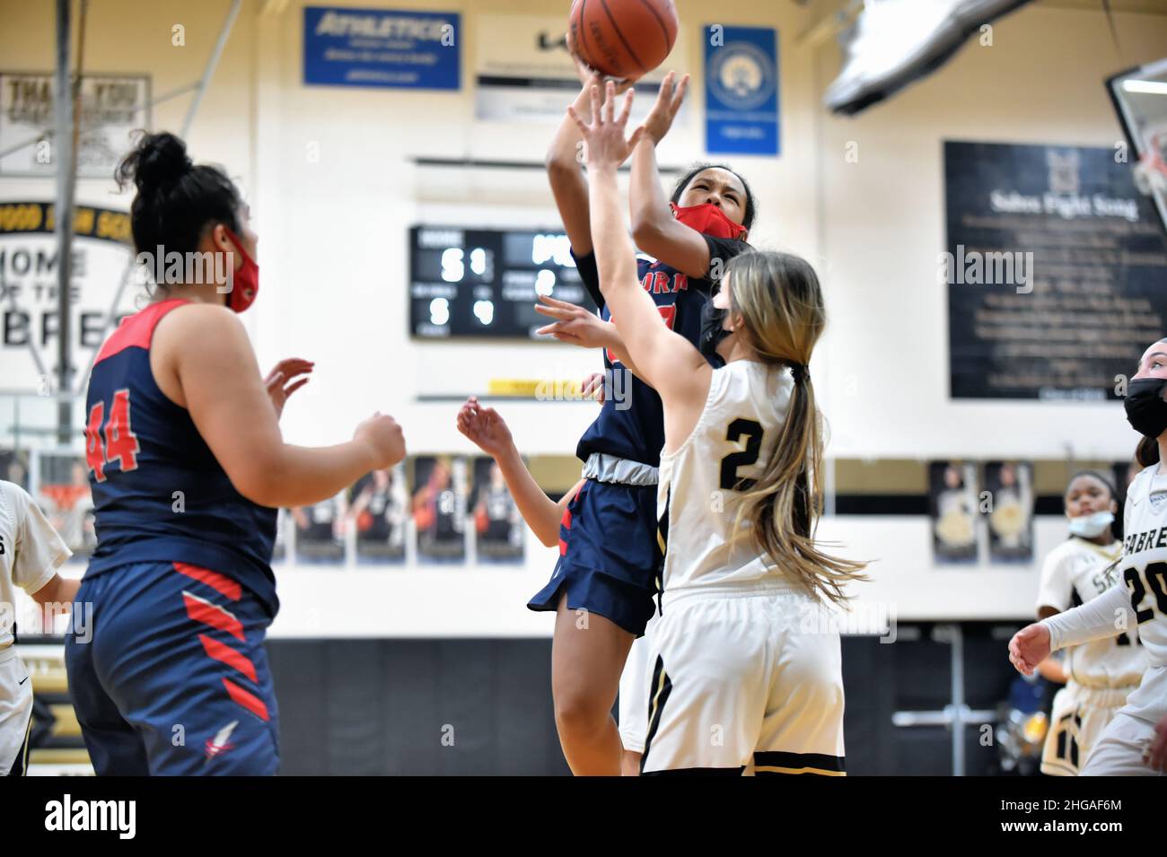 USA. Player triggering a short shot from within the paint over the defense of an opponent. Stock Photo