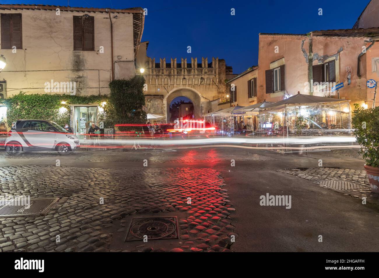 Trastevere Rome Italy at night. View of an Italian Vespa motorcycle on the street corner Stock Photo
