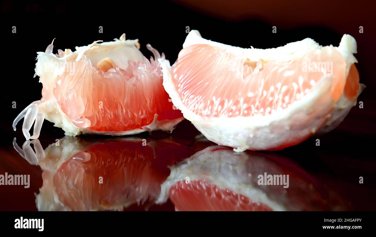 Close up photo of a fresh pomelo slices on a glossy surface,healthy food full of vitamine c and antioxident Stock Photo