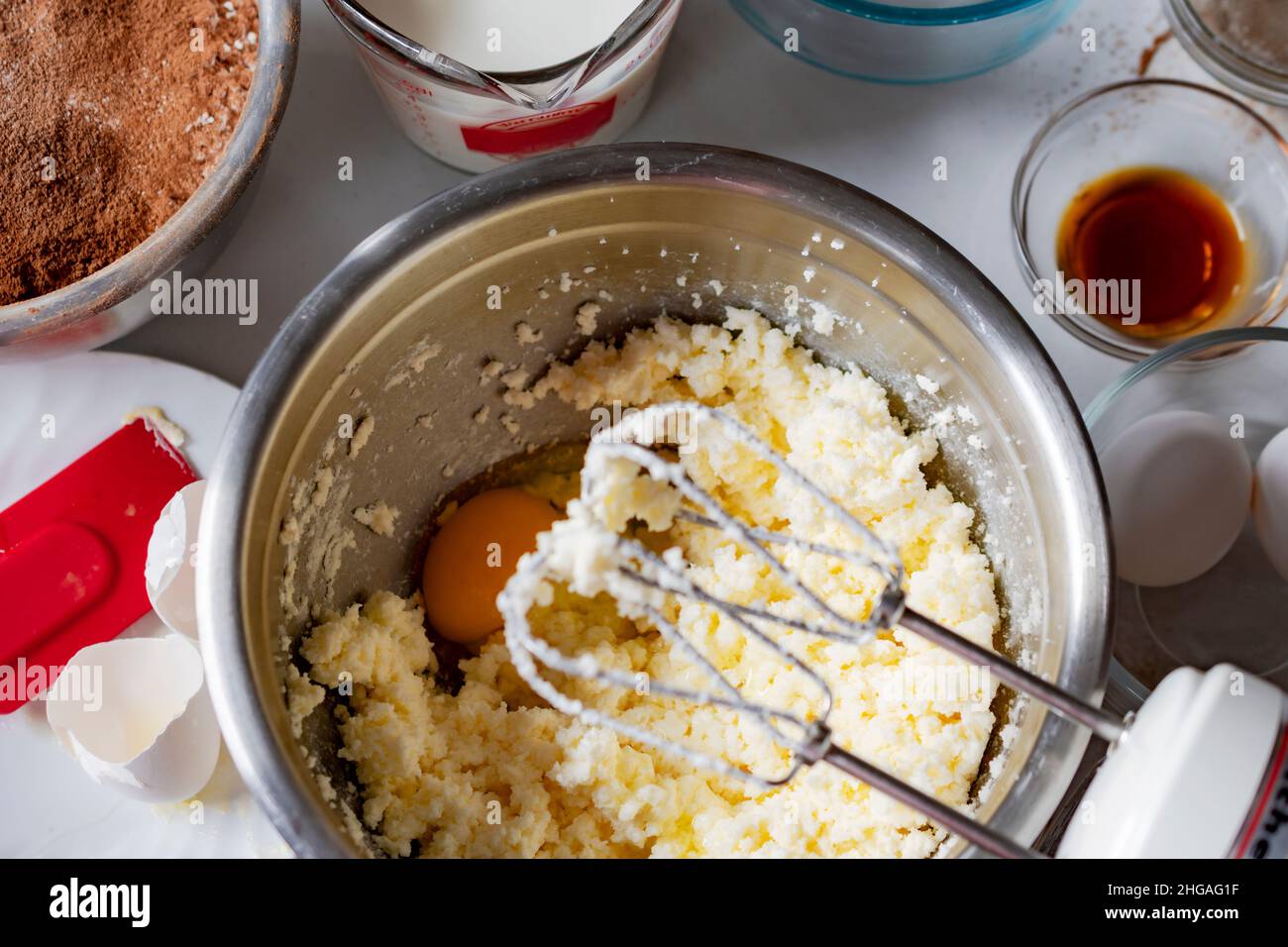 Making a chocolate cake Adding an egg, one at a time. Overhead angle
