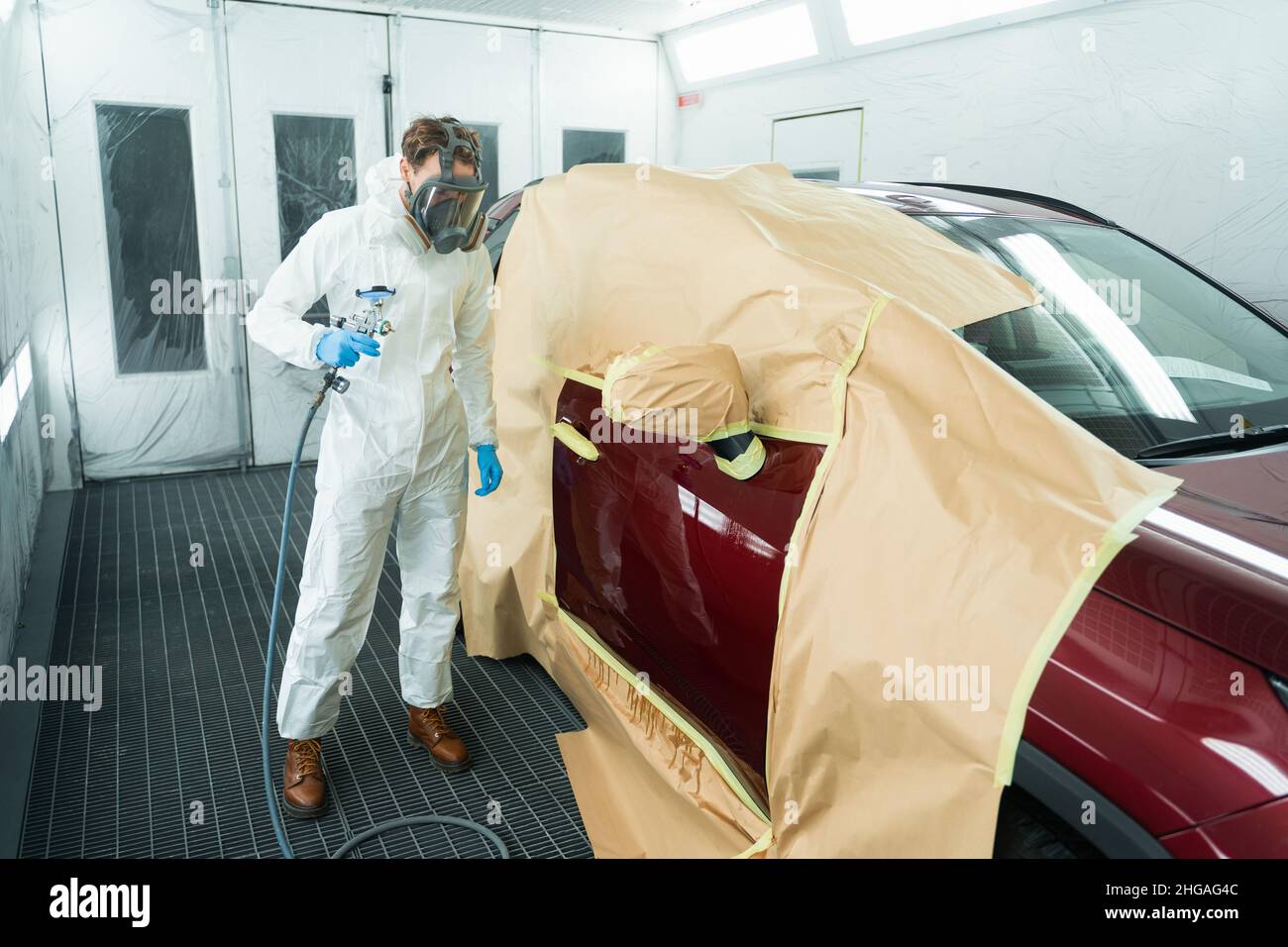 Auto painter with spray gun in car painting booth Stock Photo Alamy