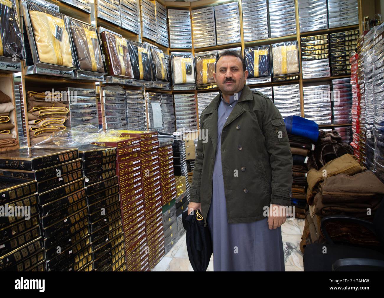 Clothes seller in his shop, Riyadh Province, Riyadh, Saudi Arabia Stock