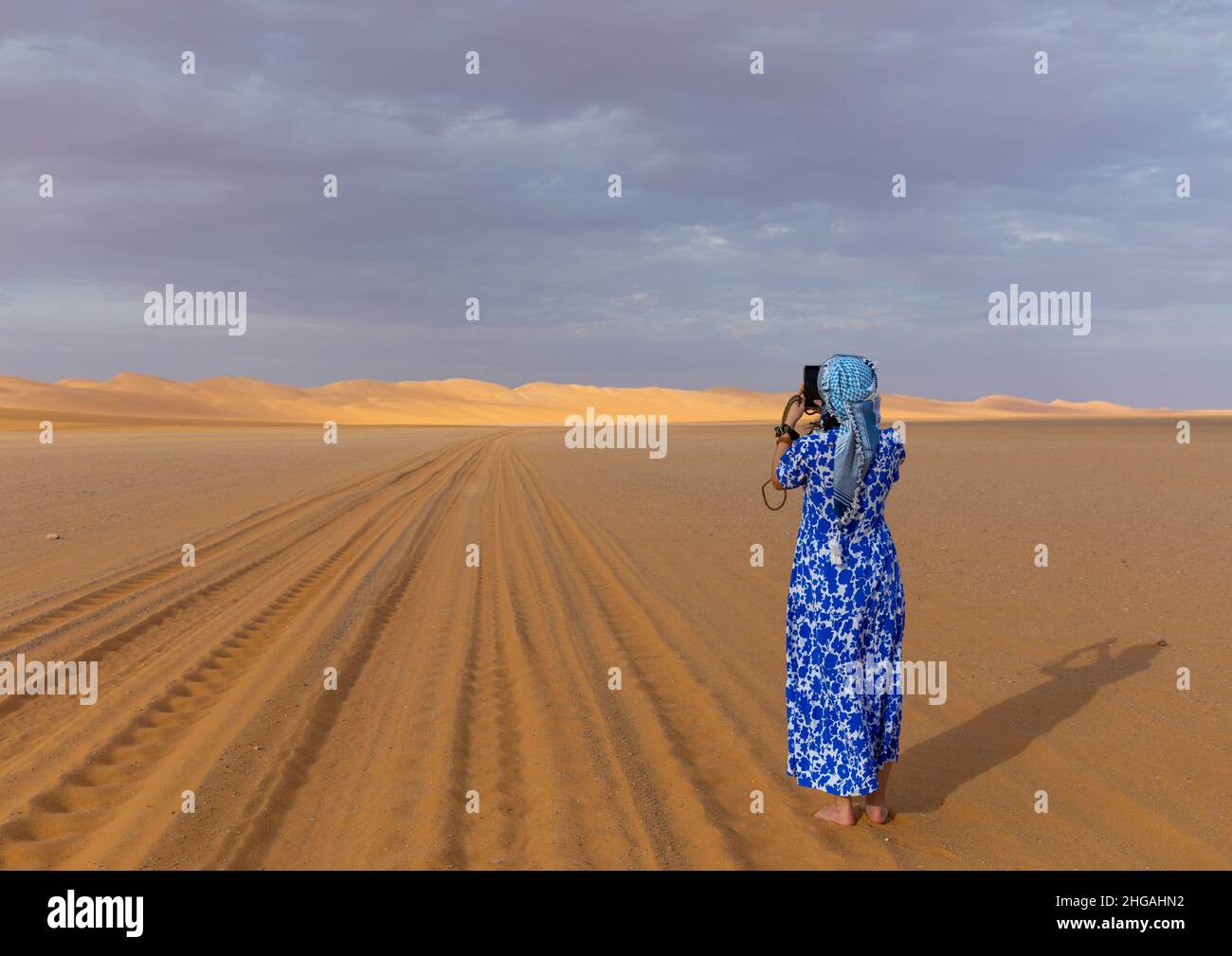 Tourist taking picture of a Rub al Khali dune, Najran Province, Thar, Saudi Arabia Stock Photo