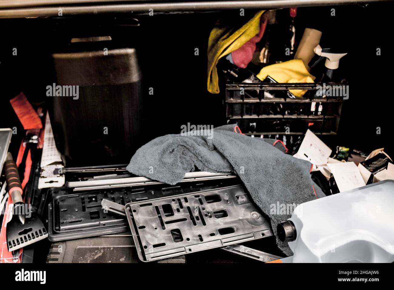 Open trunk of a car in which a mess.Tools and debris in the trunk Stock Photo