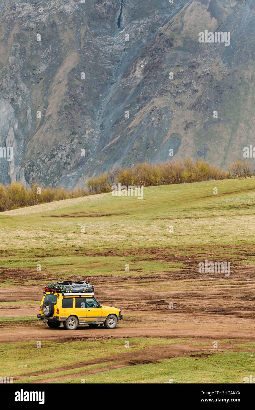 Land Rover Discovery Suv Car On Off Road In Spring Mountains Landscape In Georgia. Mid-size Luxury Suv, From The British Car Maker Land Rover Stock Photo