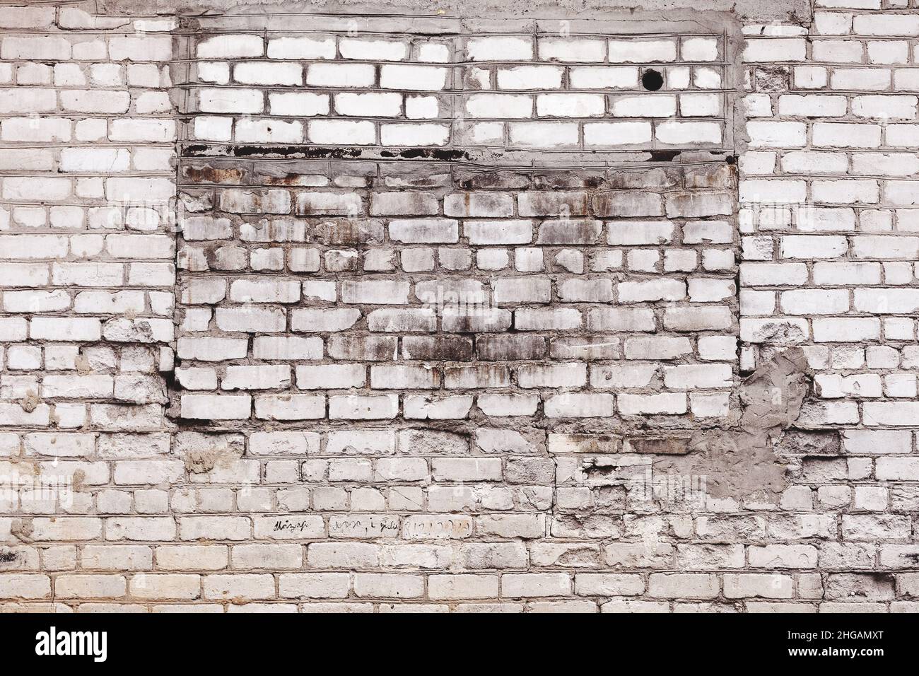 Abstract background old white brick wall with cracks and scratches ...