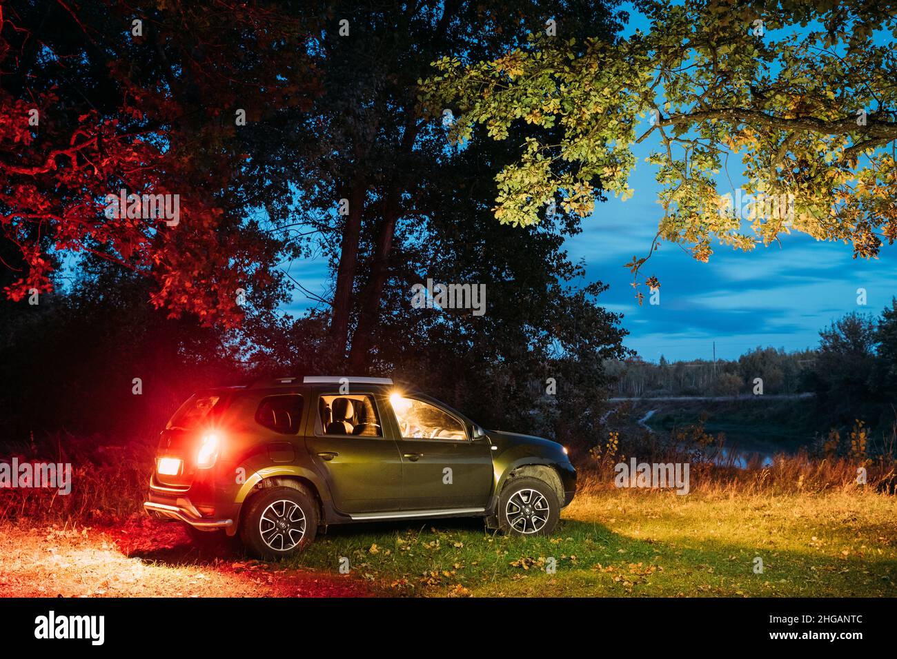 Car Renault Duster SUV in autumn night forest. Duster produced jointly ...