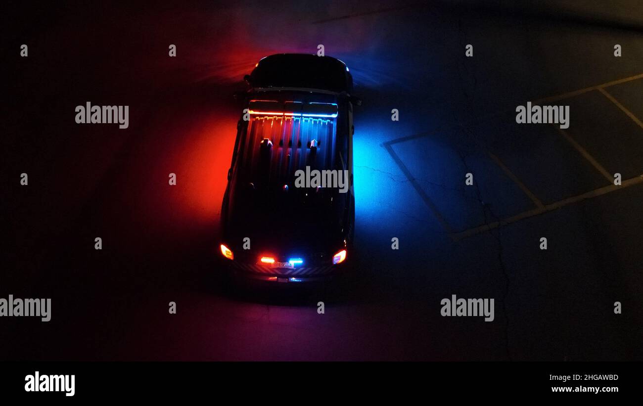 Police SUV at night with lights on Stock Photo