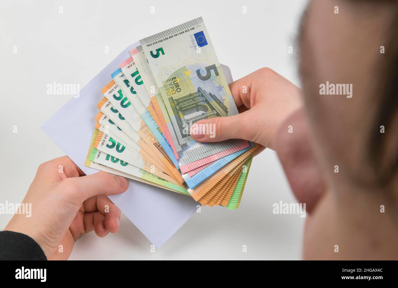 Hand, money envelope, symbol photo pay packet, studio shot Stock Photo