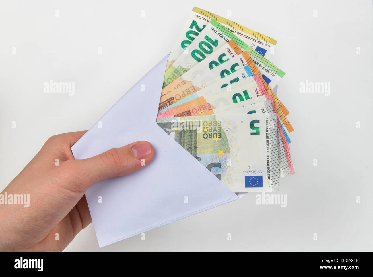 Hand, money envelope, symbol photo pay packet, studio shot Stock Photo
